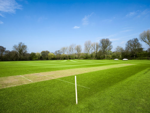 Groundsperson cutting grass