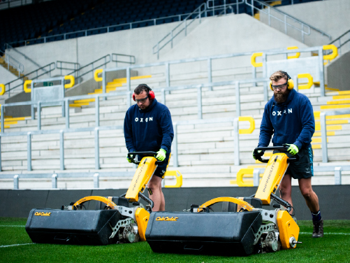 Groundsperson cutting grass